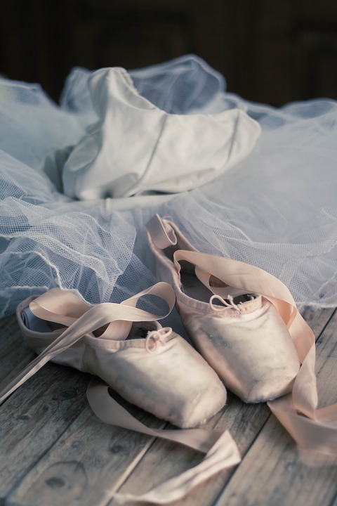 Pink pointe shoes and a white tulle dress.